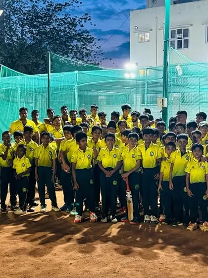Our hostel boys team gathers for a group photo at the nets during an evening session.