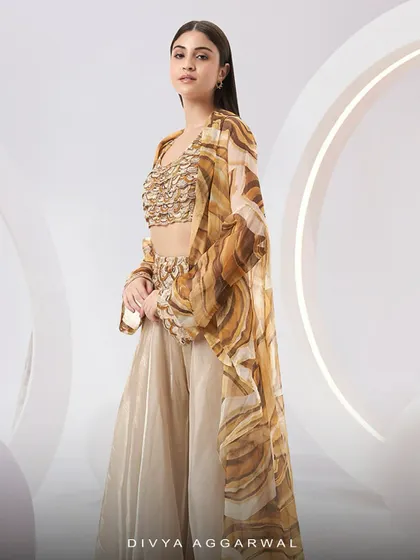 The Adoree Cape Set, a vision of modern elegance with its printed oversized cape and hand-adorned bustier.