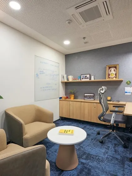 This executive cabin is designed to be both a private workspace and a small meeting area. It features an ergonomic chair, an adjustable-height desk, and comfortable visitor chairs, all within a compact and well-lit room.
