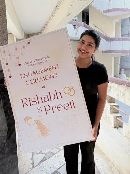 There's nothing like seeing a design come to life. Here I am with the finished engagement ceremony welcome sign for Rishabh and Preeti. A personalized welcome sign at the entrance sets a warm and inviting tone for the celebration.
