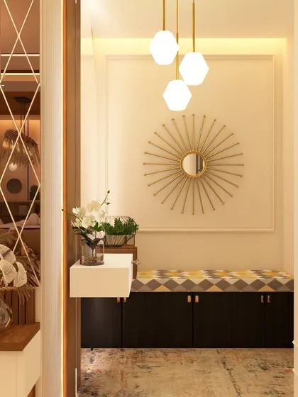 A compact and elegant entryway featuring a sunburst mirror and a cushioned bench with built-in shoe storage. This design proves that even smaller spaces can be highly functional and aesthetically pleasing with smart planning.