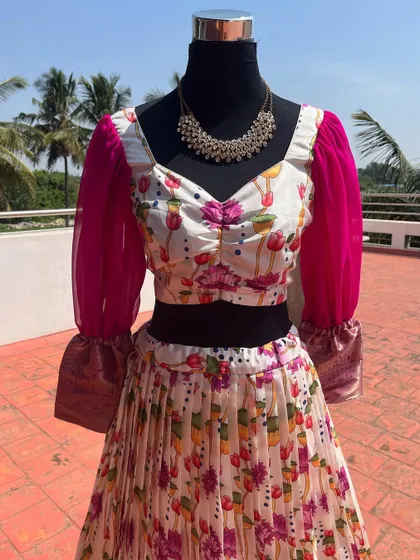 A close-up of the floral blouse with ruched detailing.