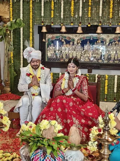 A couple seeks blessings at the Mahalaxmi Mantap. The backdrop features intricate traditional artwork and temple bells, highlighting the authentic Vedic environment where our weddings are conducted.