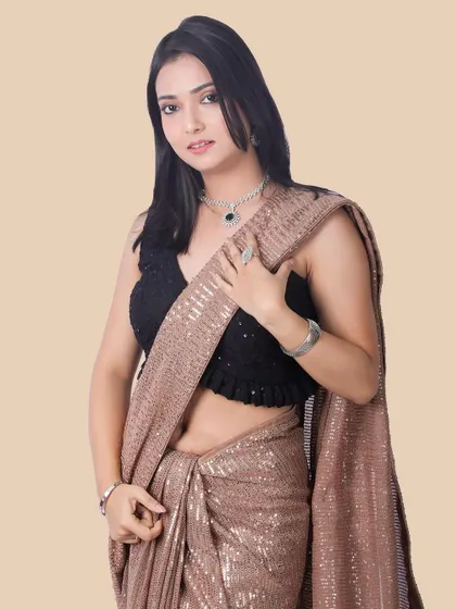 A three-quarter view that emphasizes the full drape and shimmer of the sequin saree, providing a comprehensive look at the garment.