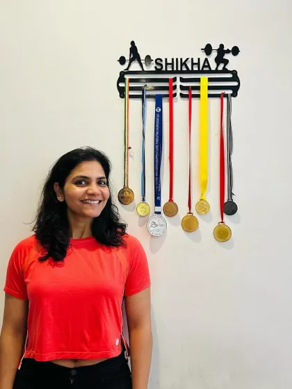 Proudly standing next to my achievements. My journey is proof that you can build a legacy of strength at any stage of life.