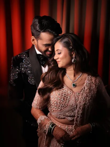 A romantic moment between the couple. The bride's makeup is soft and glowing, perfect for a night of love and celebration.