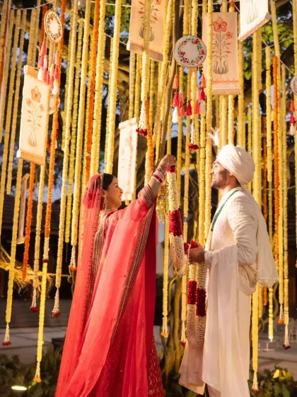 A unique 'tree of life' concept where the couple participates in a ritual amidst hanging floral garlands and custom-painted scrolls. This interactive element makes the ceremony deeply personal and symbolic.