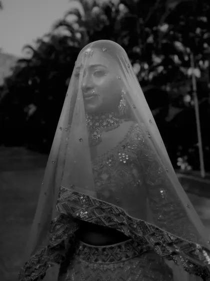 A moody and emotional black and white portrait of the bride under her veil.