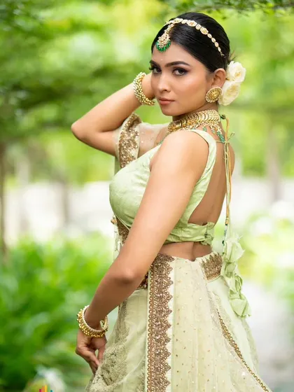 The back view of the pastel green lehenga's blouse, featuring a simple yet elegant deep-back design.