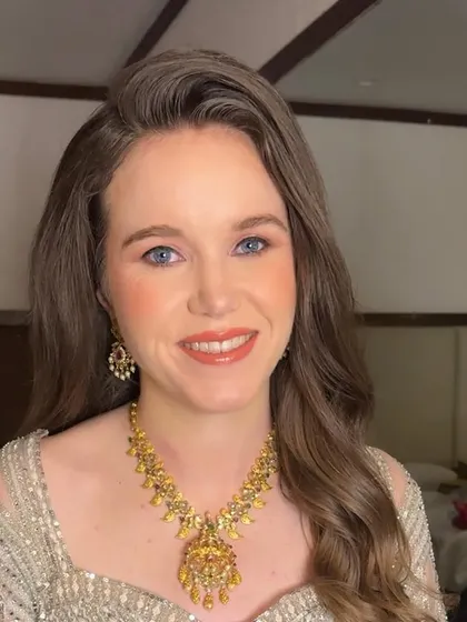Sarah looking directly at the camera, her blue eyes sparkling. The makeup is minimal yet effective, highlighting her best features.