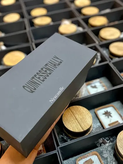 This is a custom corporate gift box we designed for a client, featuring their brand name "Quintessentially" on the lid. We manage the entire process, from sourcing the box to filling it with our handcrafted products, ensuring a professional and high-quality result.