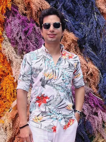 Hello, happiness. Feeling blessed and ready to kickstart the journey, posing against a vibrant, textured wall that matches the energy I feel.