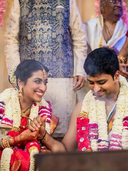 A happy, candid moment between the couple during their vibrant Tamil Brahmin wedding ceremony.