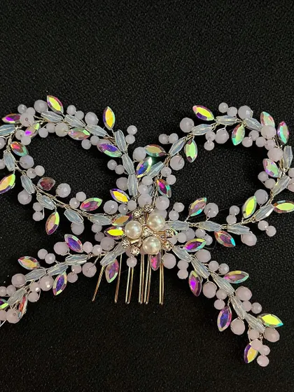 Bows are the ultimate hair accessory essential. This one is crafted with iridescent crystals and pearls for a truly unique look.