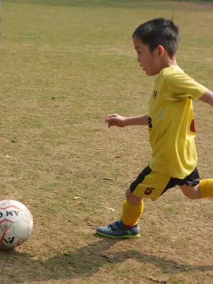A young player takes a shot. Every kick is an opportunity for growth, happiness, and learning the value of hard work.