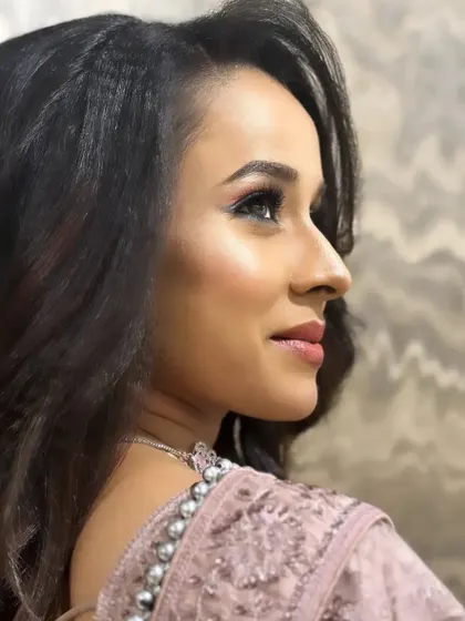 A profile view that highlights the sharp contour and glowing skin of this sophisticated party makeup.