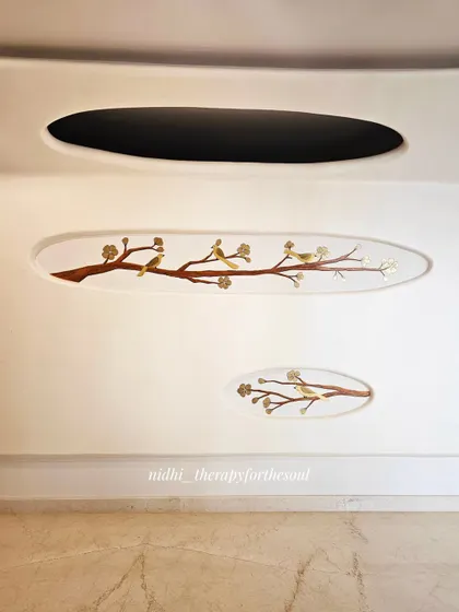 This elegant mural of birds on branches was designed to fit within specific niches on the wall, adding a subtle shimmer with gold paint that complements the home's teak interiors.