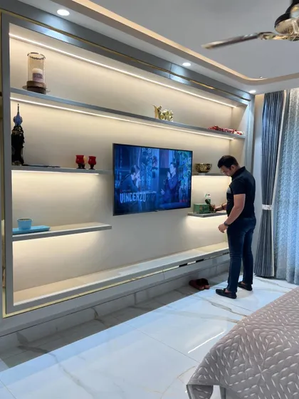 Placing the final decor items on the backlit shelves.