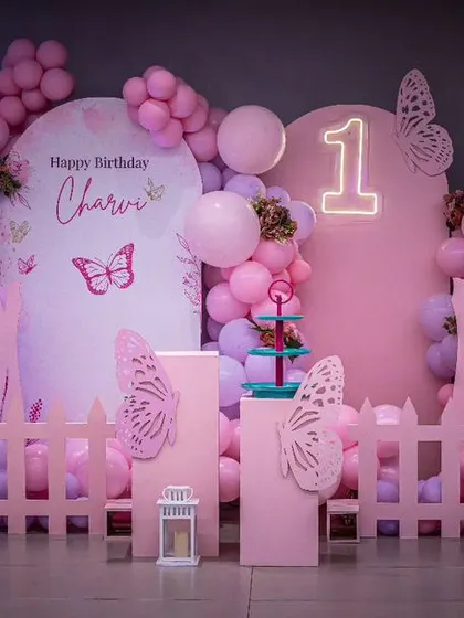 A brand new butterfly setup in shades of pink. The large, intricate wing cutouts create a stunning photo backdrop for a first birthday.