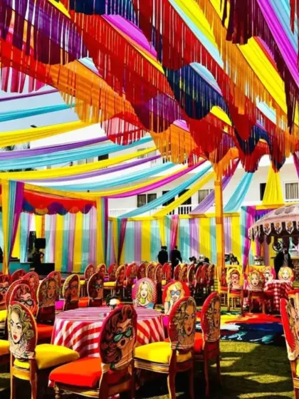 This setup shows how we can bring a fun and quirky theme to a Mehandi or Sangeet function. I used multi colored ceiling drapes and unique pop art chairs to create a vibrant and energetic vibe that encourages celebration.