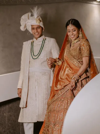 Another shot of the couple, capturing their smiles and the beautiful details of their outfits.