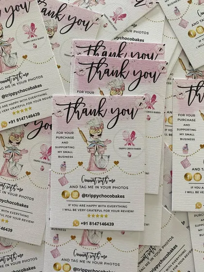 A stack of freshly printed thank you cards, ready to be included in customer orders to add a personal and professional touch.
