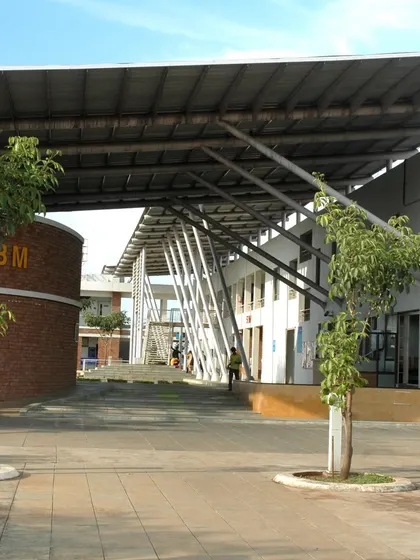 The entrance to Symbiosis International University in Pune, where exposed brick and structural steel create a modern yet grounded aesthetic. The wide, stepped plaza encourages students to gather, reflecting our design principle of fostering community from the moment of arrival.