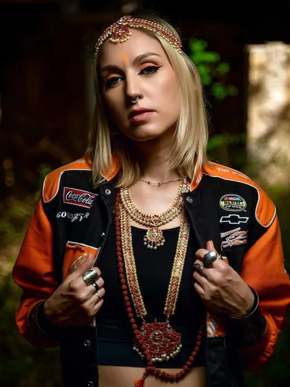 This look for Uma Shanti was all about channeling a powerful energy. The combination of a modern jacket, traditional jewelry, and a pop of neon makeup created a truly unique aesthetic.