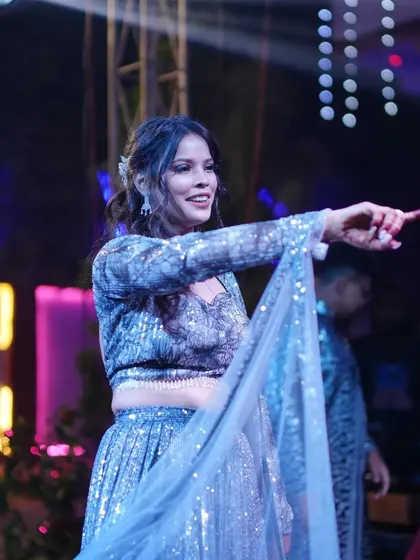 The bride pointing to her love in the audience during her solo dance. I help add these personal touches to make the performance meaningful.