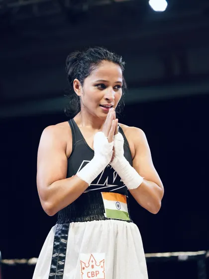 You have to believe. A female fighter in a moment of prayer and focus.