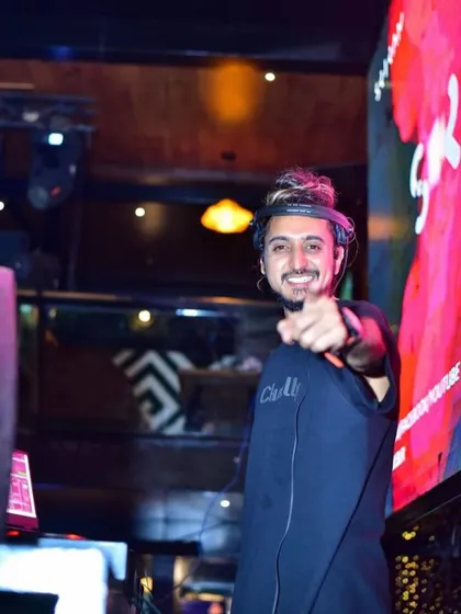 Pointing at the camera, with a confident smile. My goal is to always get better and deliver the best experience possible.