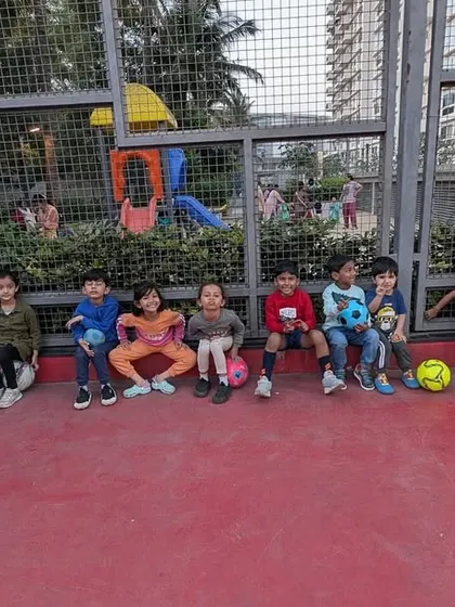 Break time! The team takes a rest, sitting together and building friendships. These social moments are just as important as the drills for developing teamwork and communication skills.