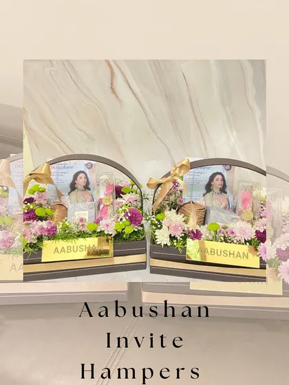 A stylized image of the Aabushan invite hampers, showcasing the beautiful floral arrangement and custom branding.