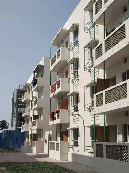 The facade design for the Happinest buildings incorporates simple yet effective shading devices over windows and balconies. These overhangs are a passive cooling strategy that helps keep the apartments comfortable without relying heavily on air conditioning.