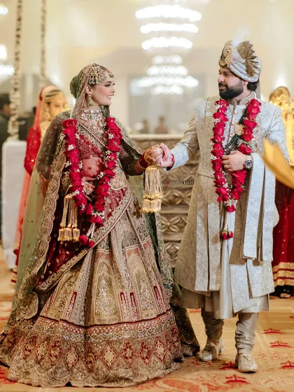 A candid shot of the couple walking together after their royal wedding ceremony, sharing a happy moment.