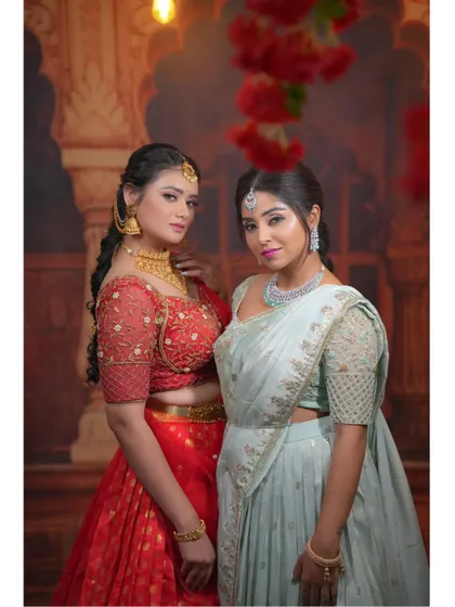 A close-up portrait of the two models, showcasing their coordinated ethnic looks.