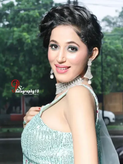A close-up of a model in a light sea-green lehenga. The sequined blouse and simple diamond choker create a fresh and modern party look.
