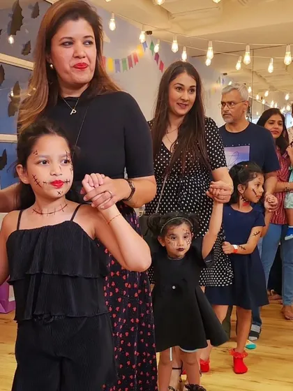 Kids and parents line up for a fun activity, showing off their spooky and cute Halloween face paint. Our events are a great way for the whole family to celebrate together.