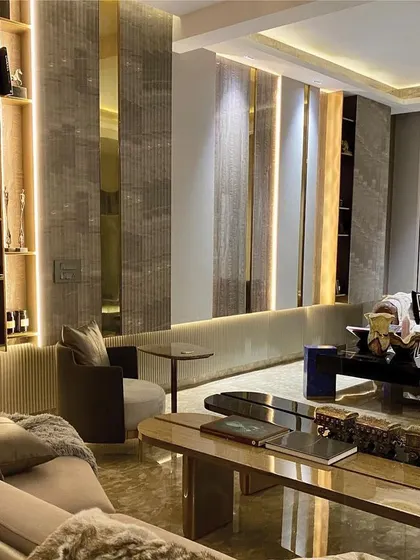 This lounge demonstrates our mastery of material and light. We combined textured wall panels with polished brass and mirror inserts, using integrated backlighting to create a warm, sophisticated ambiance perfect for an evening setting.