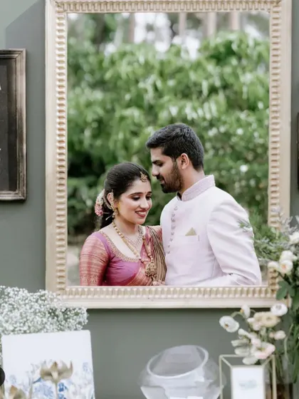 For Inchara and Chirag's engagement, we created this unique photo booth. A large, ornate golden frame was mounted on a custom green wall, allowing the couple and guests to capture picture-perfect memories.