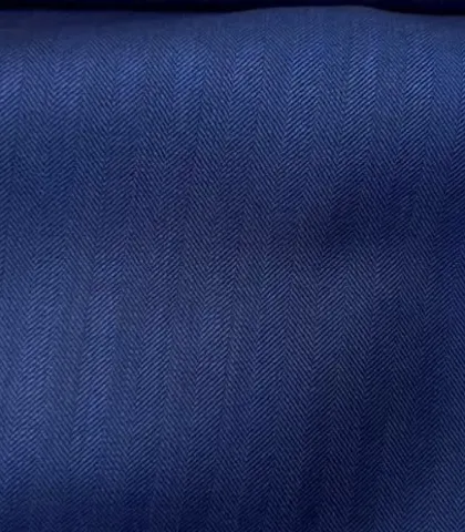 A deep blue herringbone fabric. The subtle pattern adds texture and visual interest to a classic blue blazer or suit.