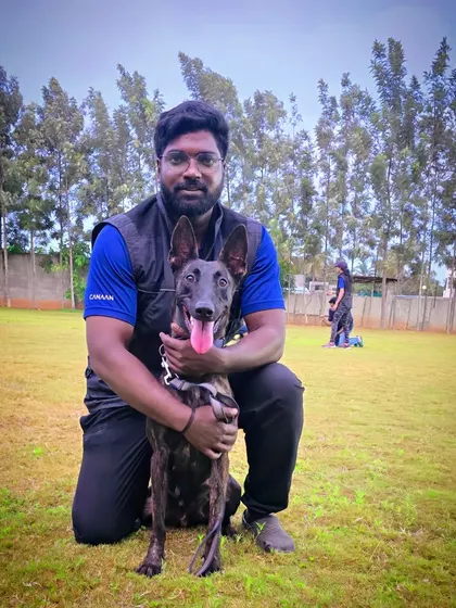 Here I am with a wonderful Belgian Malinois during an advanced obedience session in our spacious training ground. We have the expertise to handle high-energy and intelligent breeds, focusing on structure, discipline, and a strong handler bond.