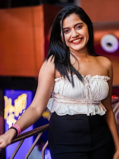 A guest smiling on the balcony, enjoying the party from a different perspective.