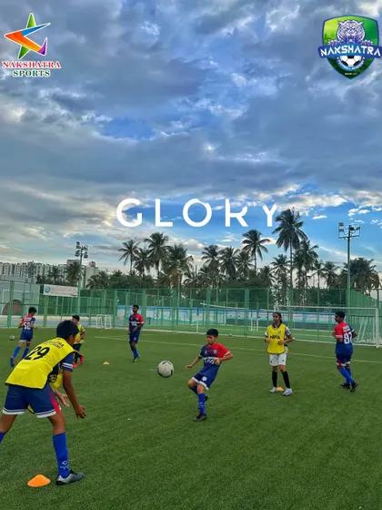 Chasing the ball, chasing the glory. Players in action during a competitive game under a dramatic sky.