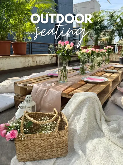 A beautiful shot of our outdoor seating arrangement. The combination of the rustic wooden table, soft pink runner, and fresh flowers creates a simple yet elegant look.
