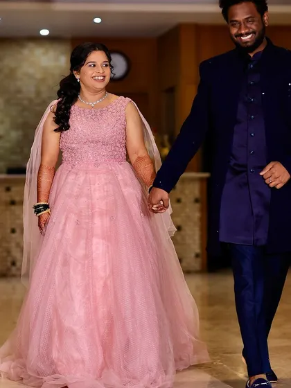 A happy couple on their engagement day. The bride is wearing a beautiful pink gown with makeup that is soft, romantic, and picture-perfect.