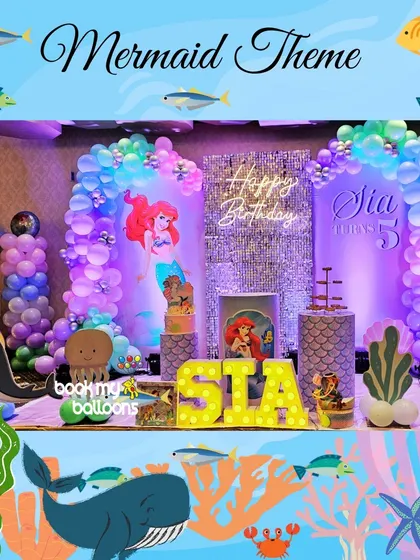 An enchanting mermaid theme for a fifth birthday, showcasing a shimmering backdrop, character cutouts, and balloon arrangements that create an under-the-sea atmosphere.