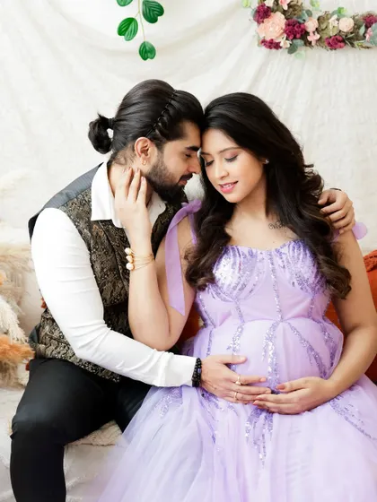 A tender and romantic portrait of an expecting couple. The soft lighting and their gentle embrace create a feeling of warmth and love.