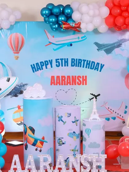 A magical 'Mermaid' themed birthday party, with shimmering blue and green decor, seashell props, and mermaid cutouts, creating an enchanting underwater world.