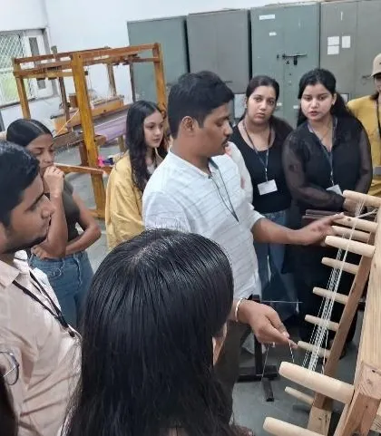 An expert at the Weaver's Service Centre demonstrates the intricate workings of a handloom to our attentive fashion and textile design students.